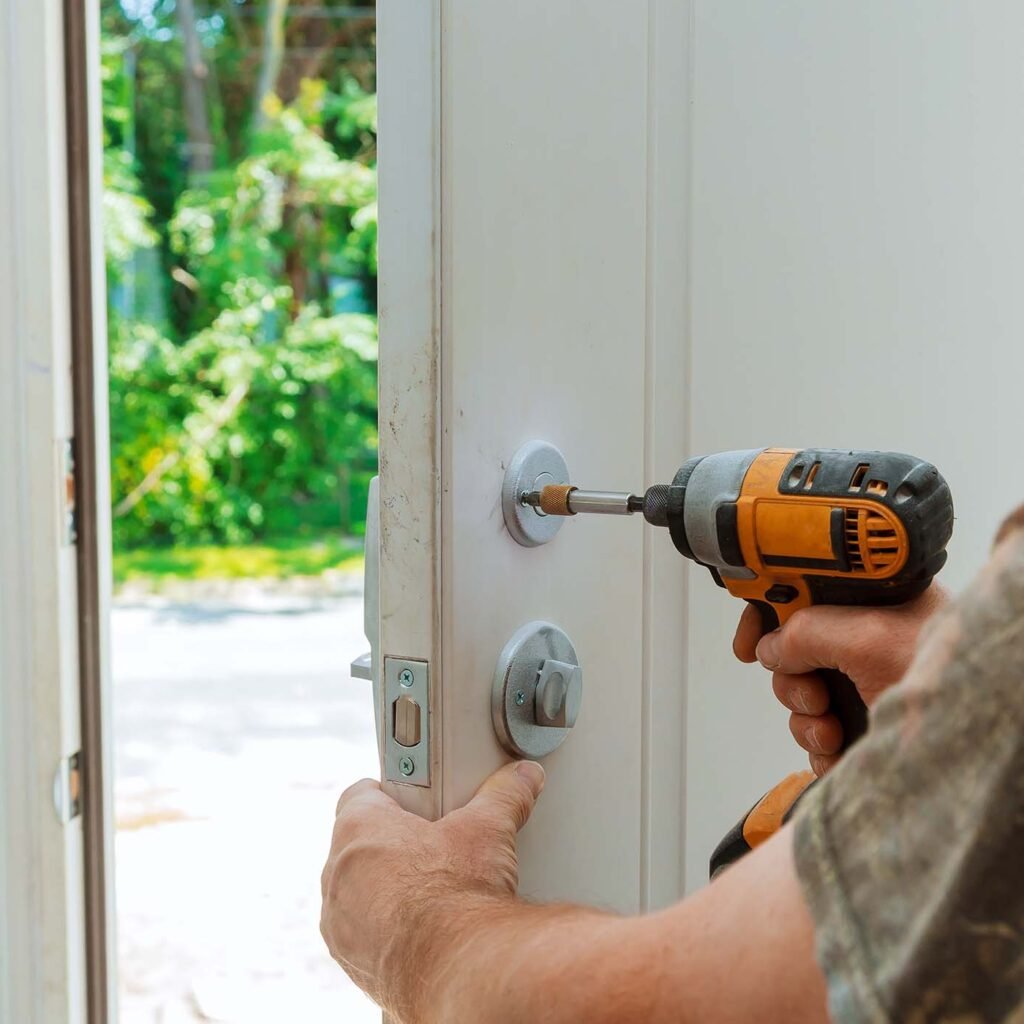 attractive-young-builder-is-installing-lock-in-doo-ARGYNKS.jpg